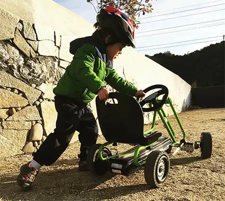 boy playing on pedal power go kart