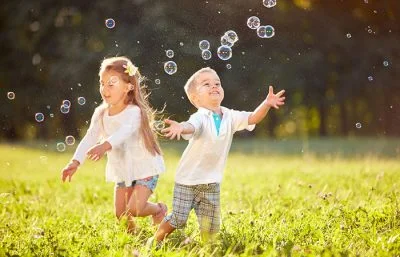 Kids playing with bubble machine